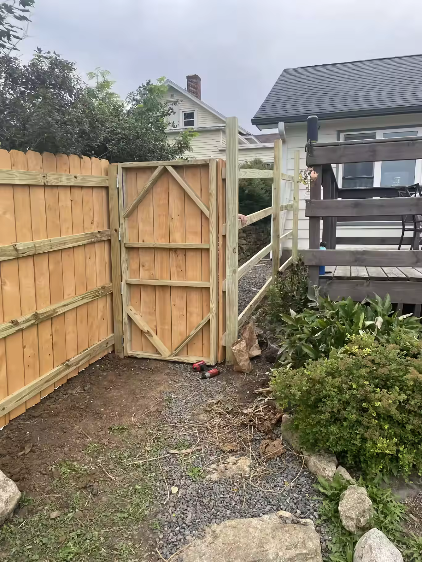 Custom-built wood fence gate with diagonal bracing