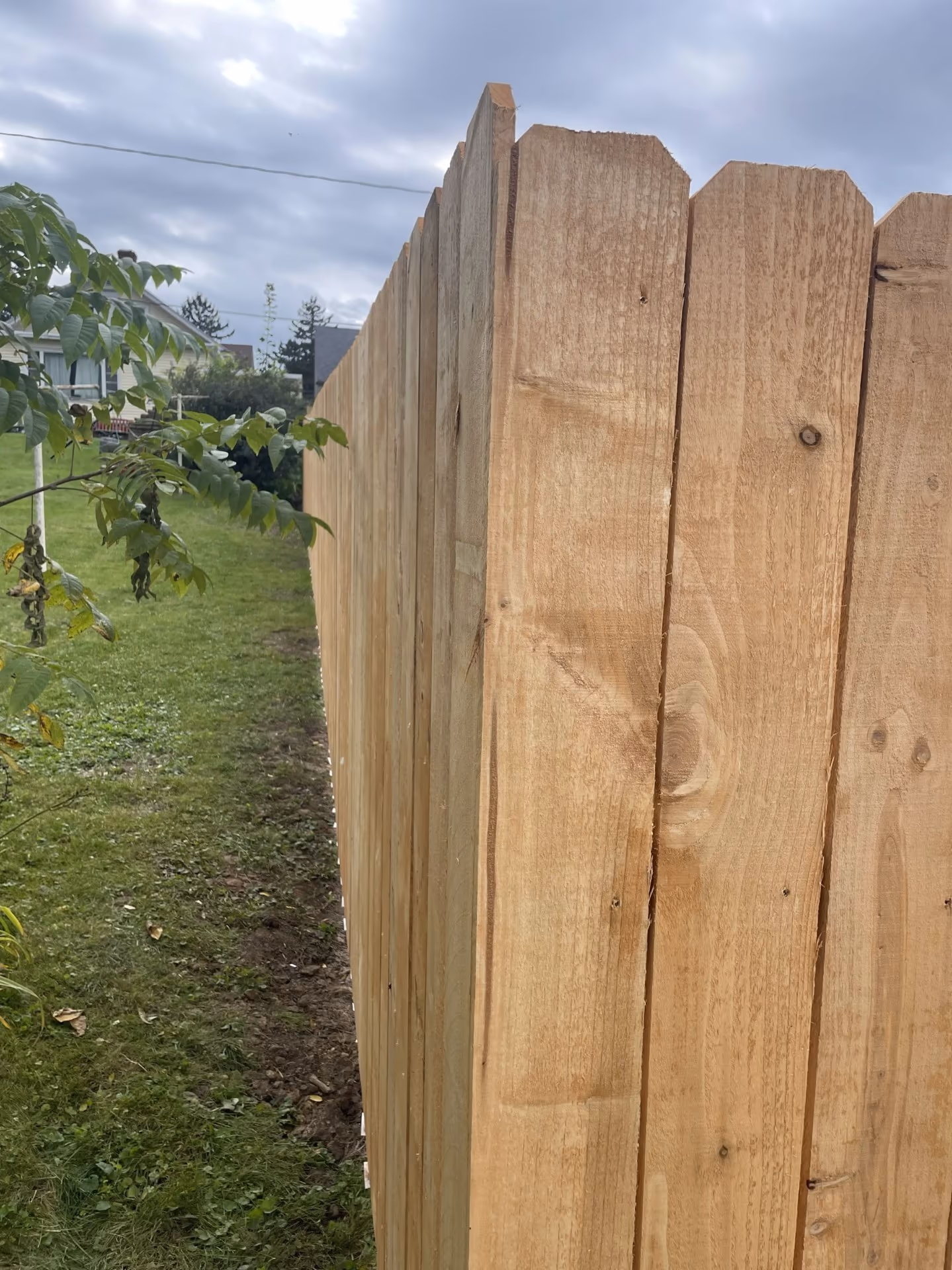 Fence installation — finished cedar dog-ear pickets