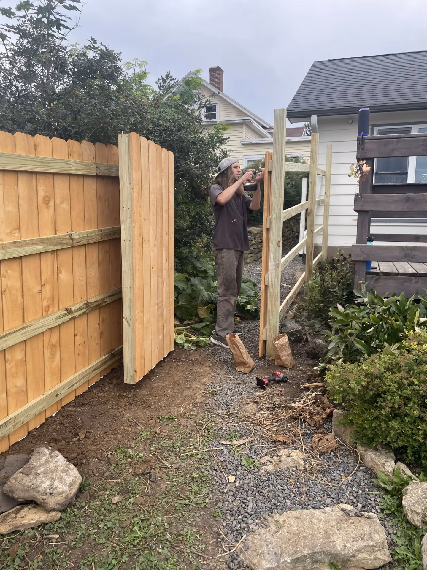 Fence installation — attaching pickets near gate