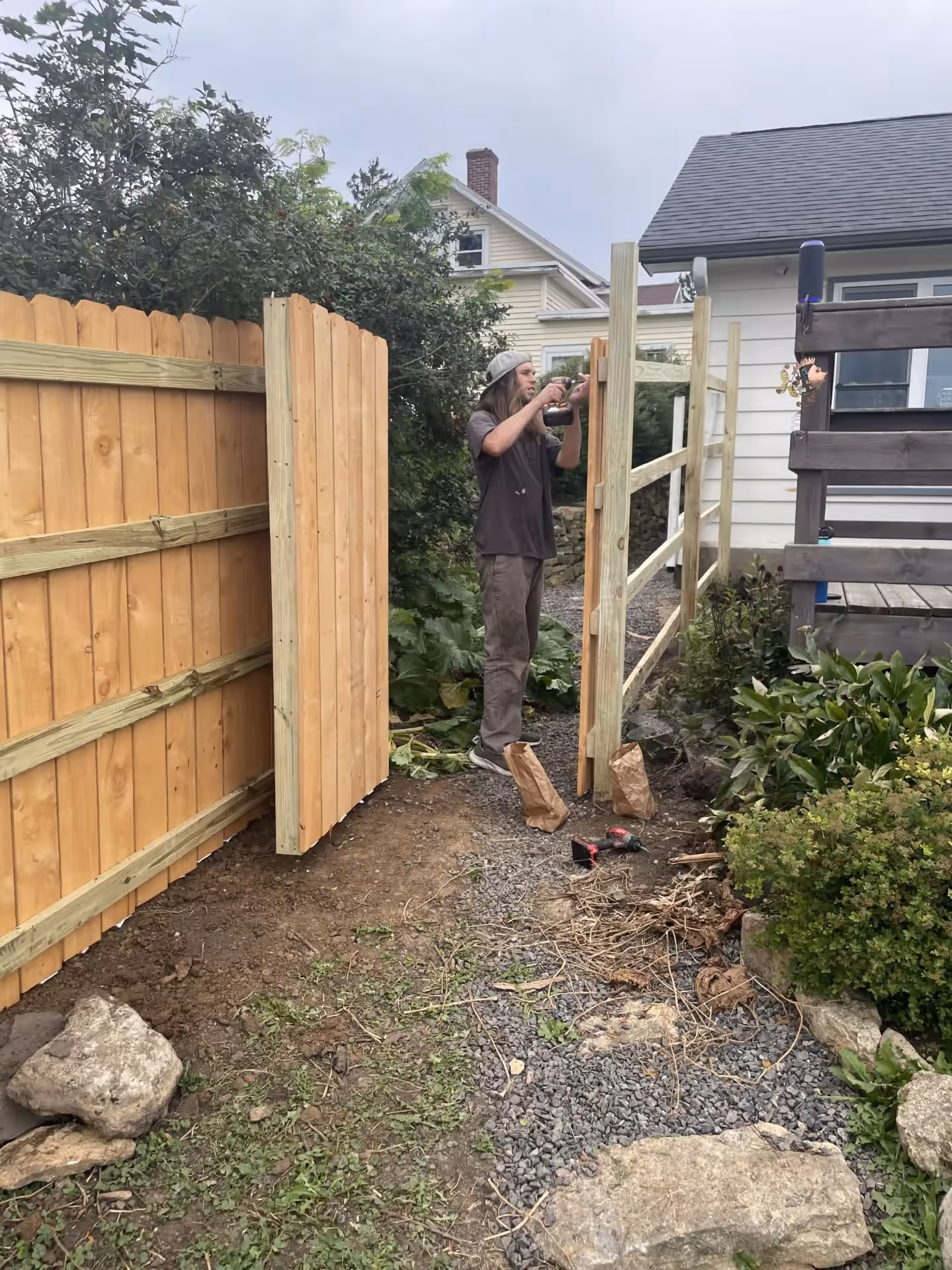Fence installation — attaching pickets near gate